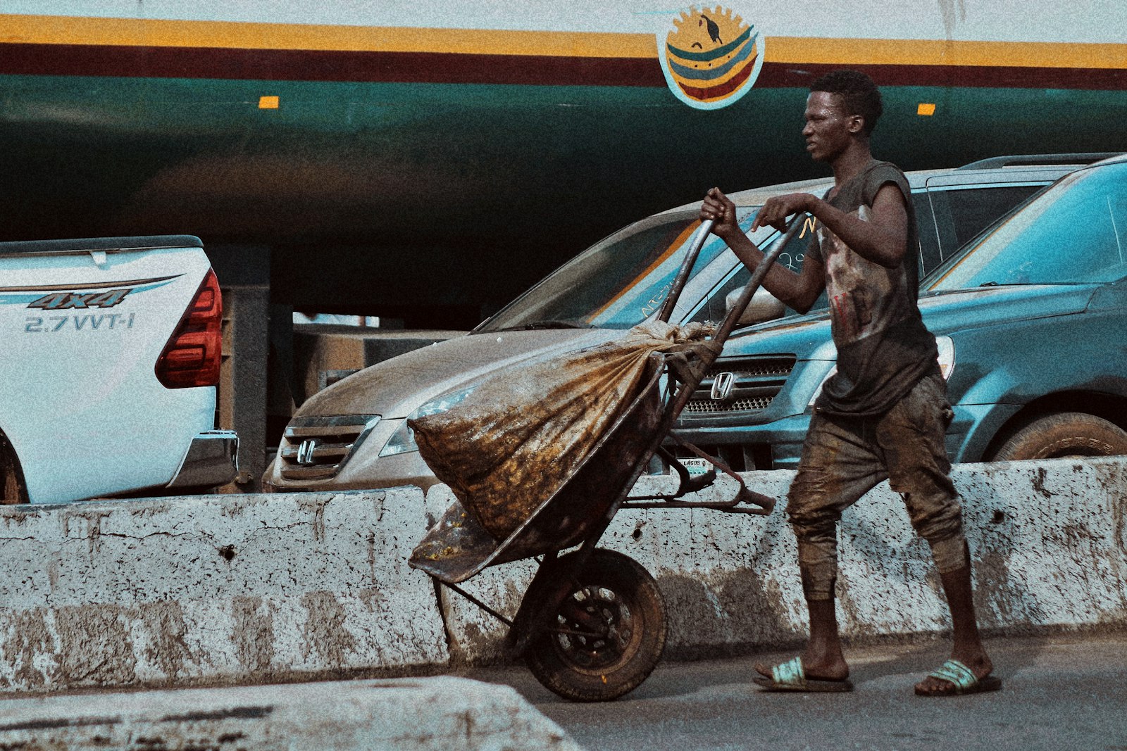 A street trader in Lagos pushing a cart.